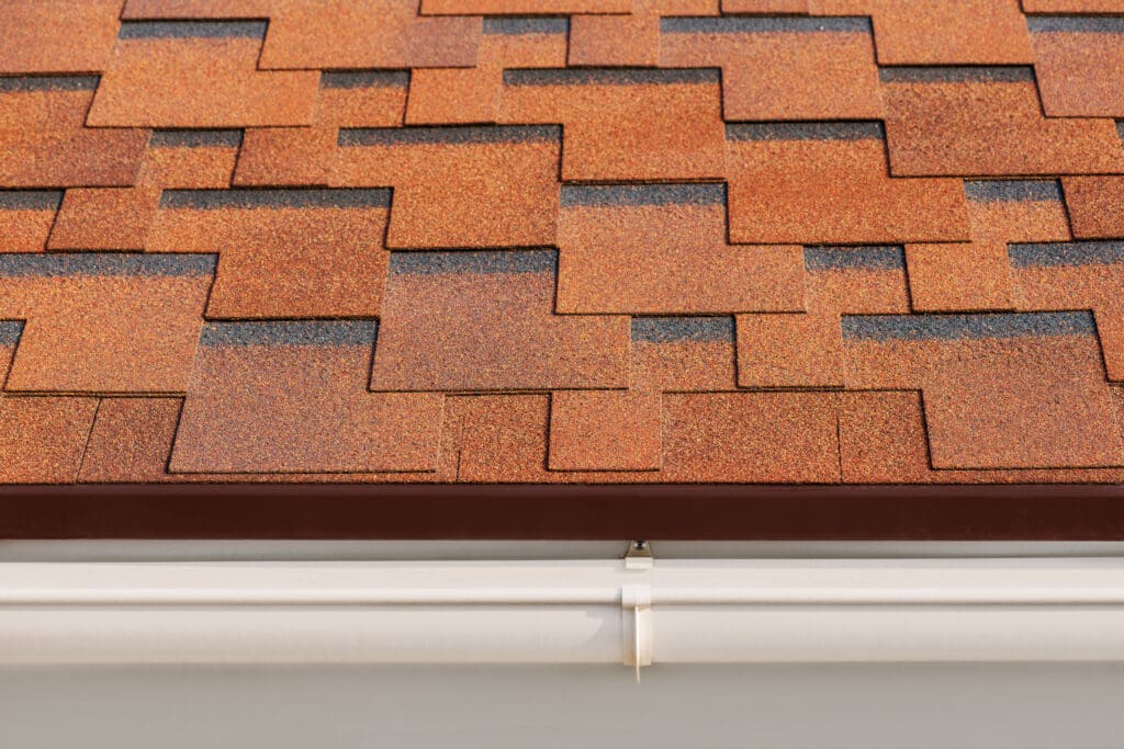 An image of rust colored Bitumen asphalt shingles to help illustrate cedar shake Roof vs Asphalt.