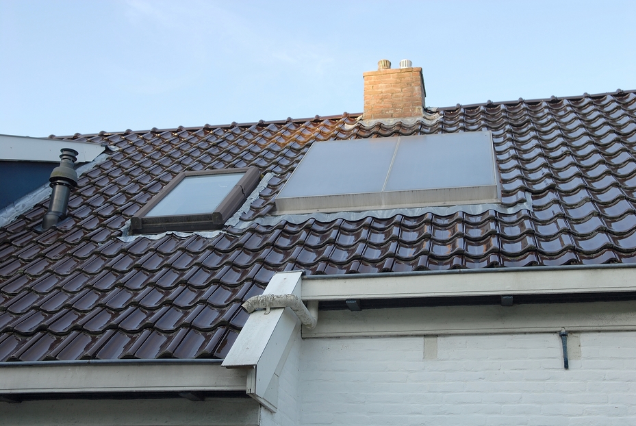 The top of a home with a metal roof and skylights to help illustrate installing a skylight on your roof