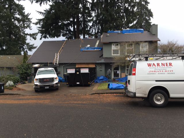 roof portfolio image with Warner Roofing van in front of a home to illustrate types of residential roofs.