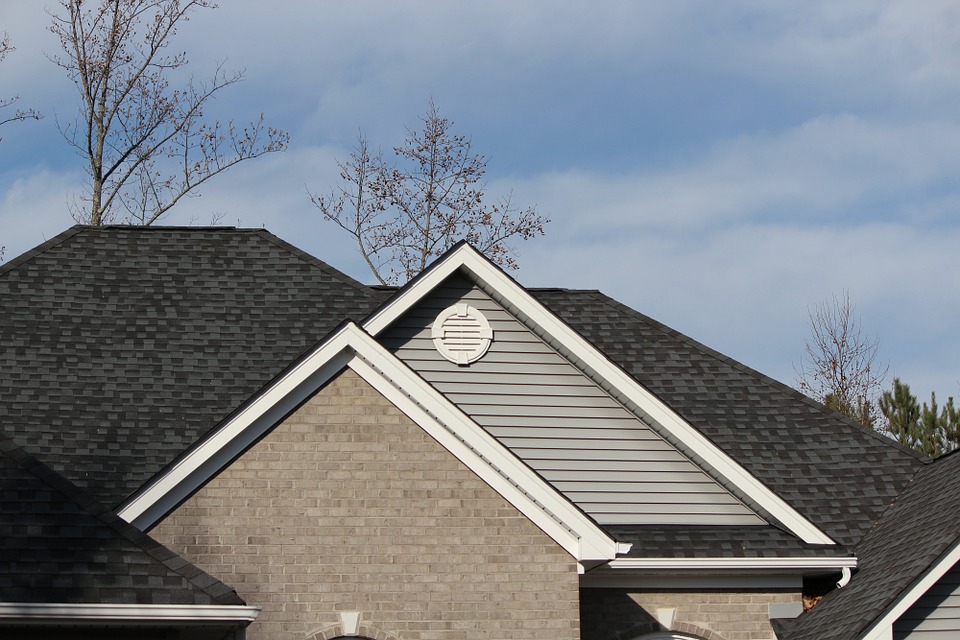 Image of the roof top of a home to help illustrate composition shingles vs architectural shingles and Cedar Shake Roof vs Asphalt.