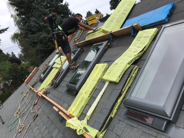 4 solar powered opening skylights with solar powered blinds 2 – Warner Roofing on a roof installation to help illustrate installing a skylight and Do I Need a Permit to Install a Skylight