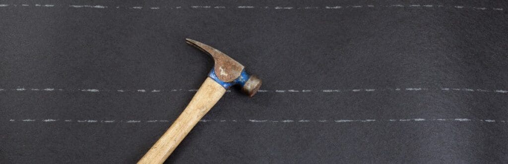 Used roofing hammer on new felt paper in horizontal format.