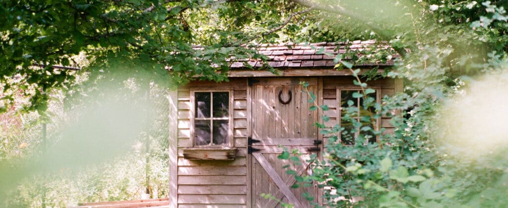 Wooden garden shed with cedar shake shingles