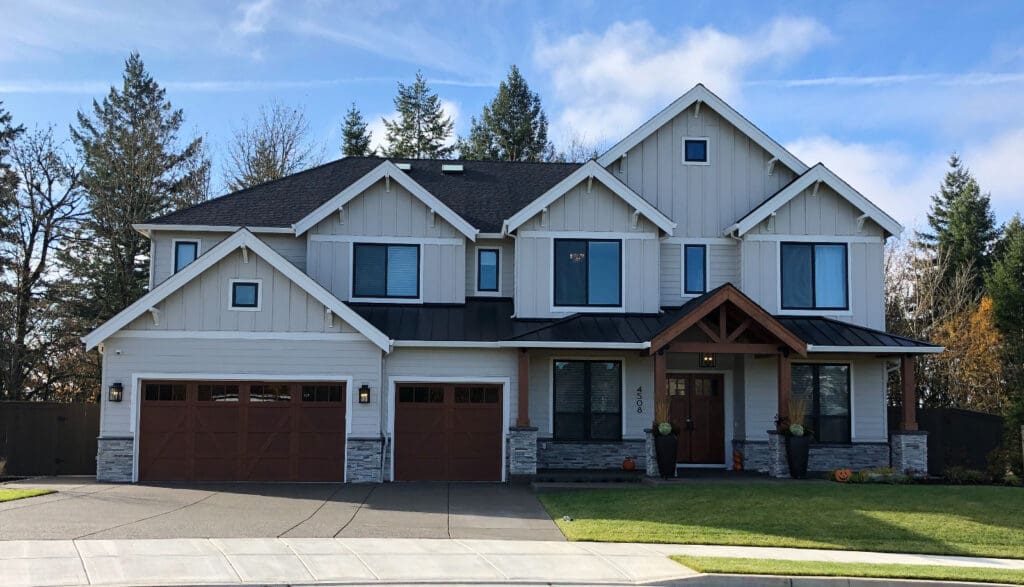 A new home with mixed roofing to illustrate what are composition shingles and different residential roofing types.