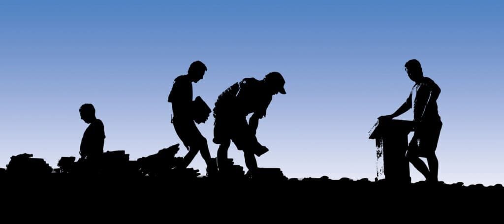 Construction workers put shingles on a roof. Silhouettes. Apartment roofing.