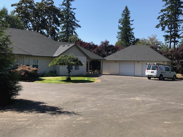 Roof tear off and replacement project in Vnacouver WA on home and garage with Warner Roofing truck