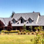 Gray asphalt shingle roofing project on a large home in the country.