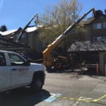 The Warner Roofing truck and roofing loading machines prepping roofs in an apartment complex
