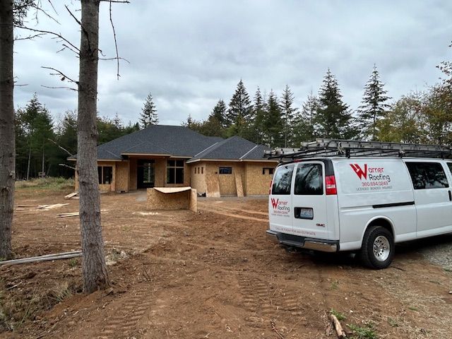 Warner Roofing truck on jobsite of new roof installation project on new home