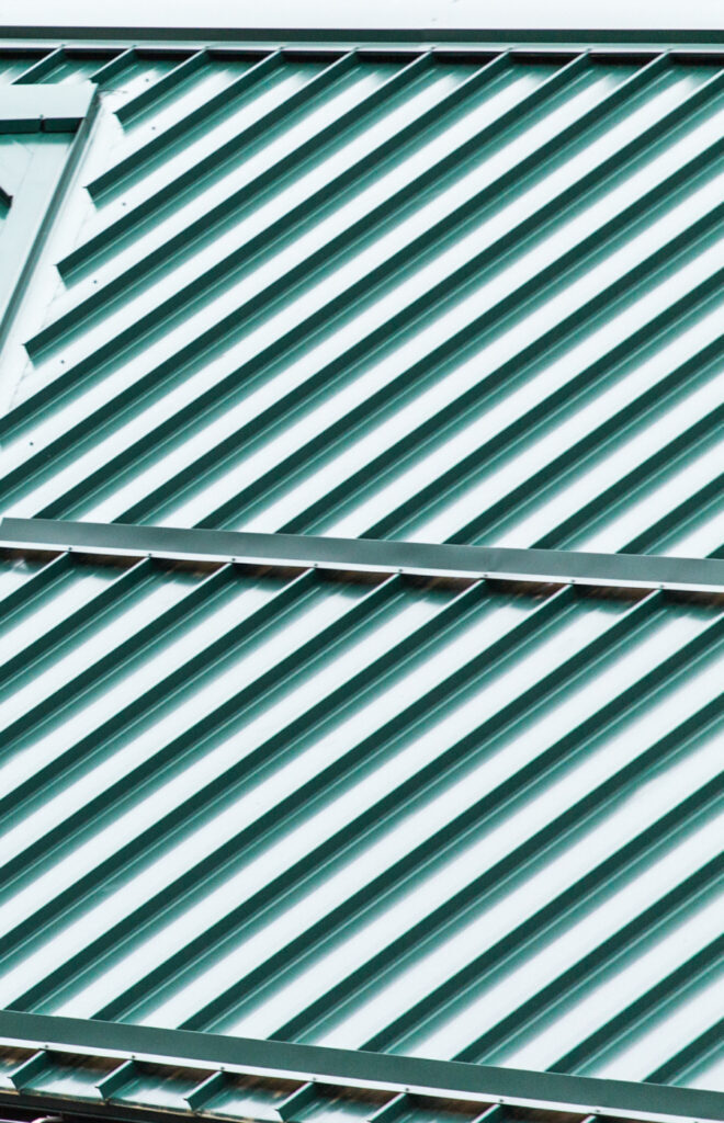 Green metal roofing to help illustrate school roofing services