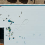 Aerial view of a flat roofing system, perhaps for a school, to help illustrate school roofing services