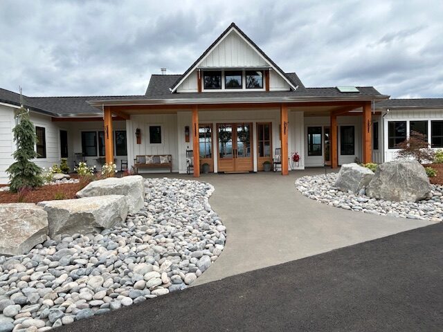 New roof installation by Warner Roofing in Ridgefield, WA on a white two-story home.