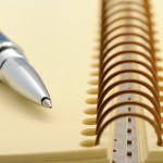 pen on a spiral bound notebook