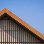 Wooden gable roof with battens decoration of vintage house against blue clear sky background to illustrate Metal Roof Insulation Maximize Energy Efficiency and Savings