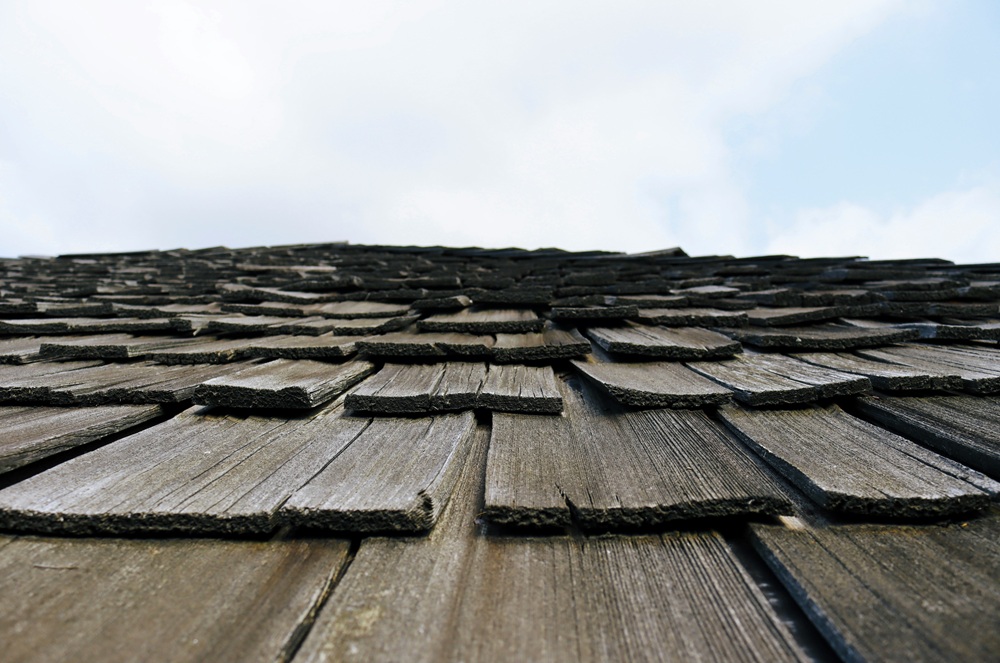 A weathered cedar shake roof to help illustrate How Long Do Shake Roofs Last