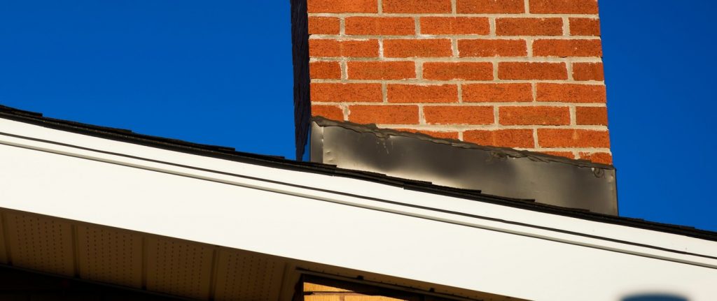 Image if a chimney with flashing around it to illiuatrate Vancouver roof flashing Warner Roofing and what is roof flashing