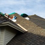 Roof shingles being replace on a home to illustrate how often should you reshingle your roof.