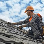 A roofer doing his work on a residential house to help illustrate Choosing a Roofing Contractor