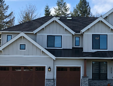 A new home with mixed roofing to illustrate what are composition shingles.