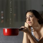 Frustrated woman looking at roof water leaks